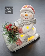 Decor ceramic Crăciun Om de Zăpadă pe sanie cu lumini LED - 12cm